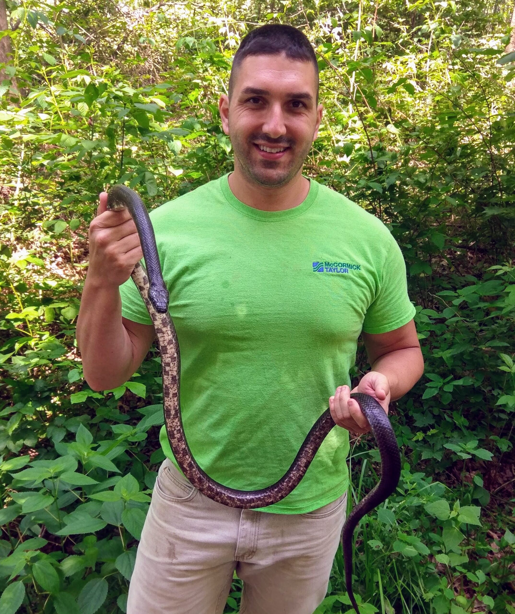 Garrett posing with a friend found in the brush after completing work!