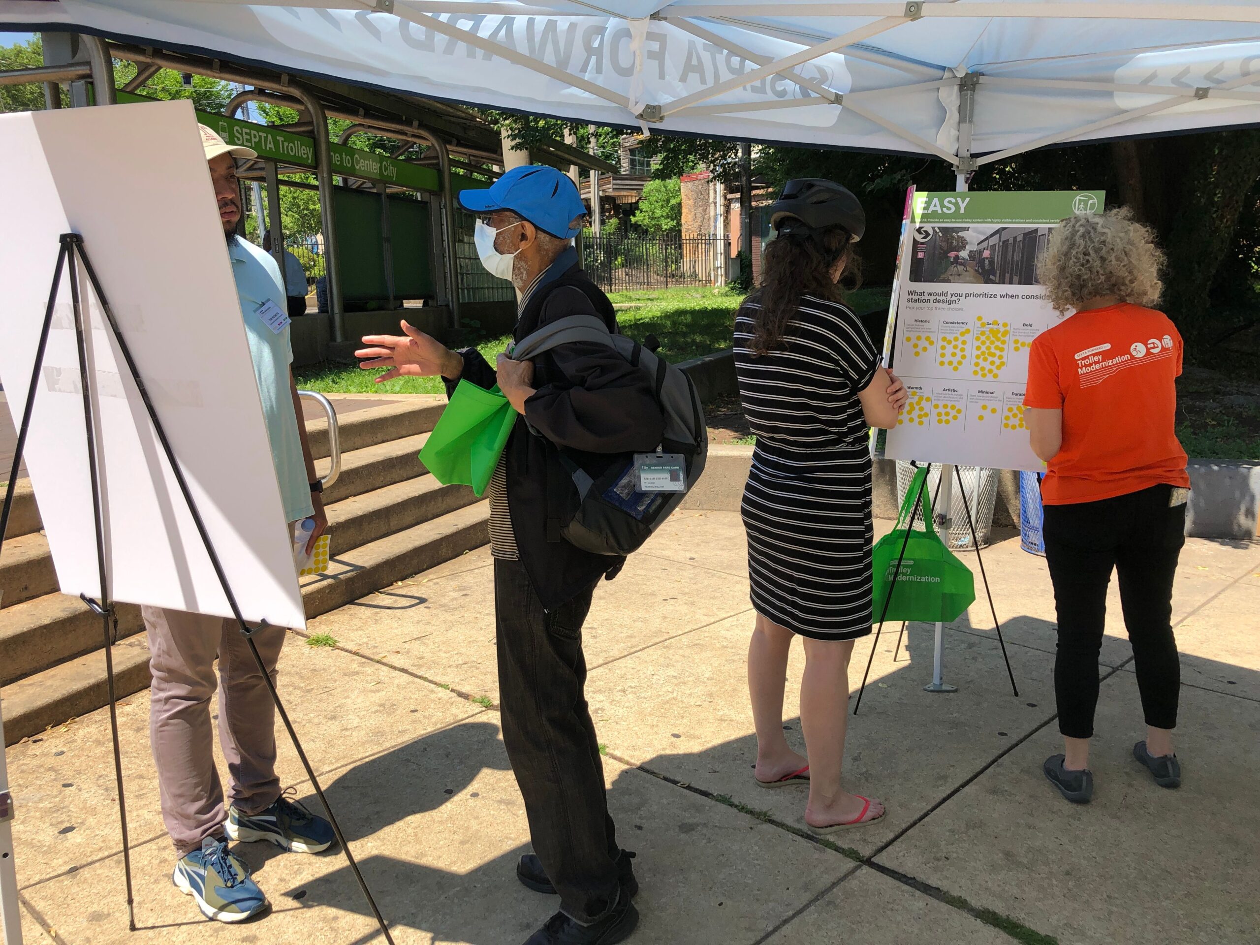 Trolley rider and a cyclist participating in the Trolley Modernization pop-up at SEPTA’s 40th Street Portal.